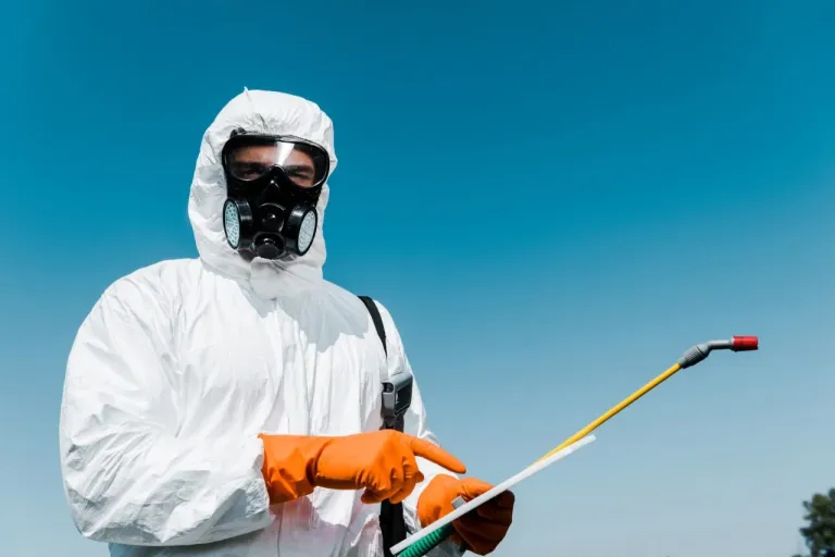 Pak Fumigation technician in protective equipment carrying out fumigation